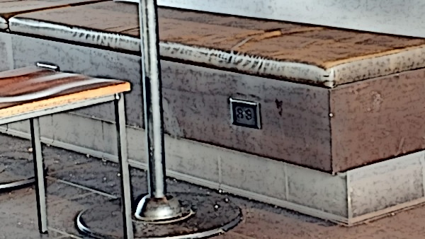An electrical outlet is displayed on a bench.